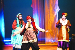 Dromio of Ephesus, played by Kristen Henrick (middle), demonstrates the Commedia delle’ arte. The Dromios wore identical masks to indicate that they are twins.  
